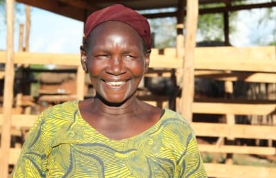 Rhoda Muthoka, Vice Chairlady of Nzwii self-help group in front of their cowshed